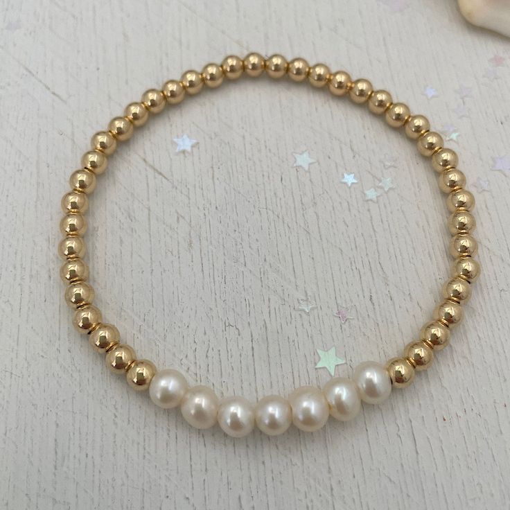 For the girls who love pearls, seven freshwater pearls on a golden strand are the epitome of a classic piece and any jewelry lovers must have! Sure to become your new favorite everyday staple. 4mm quality gold fill beads strung on super strong stretch cord accented 6mm pearls. A classic piece that you'll love and want to wear time and again. How to figure out your wrist size: use a soft measuring tap to measure your wrist. make sure to wrap the measuring tape around your wrist so that it makes c Gold Round Pearl Drop Bracelet, Gold Pearl Drop Bracelet, Dainty Gold Pearl Bracelet With Pearl Charm, Classic Adjustable Gold Bracelet With Pearls, Classic Gold Pearl Necklace With 8mm Beads, Yellow Gold Beaded Pearl Bracelet, Dainty Gold Pearl Chain Bracelet, Gold Beaded Bracelets With Pearl Drop, Gold Beaded Bracelet With Pearl Drop