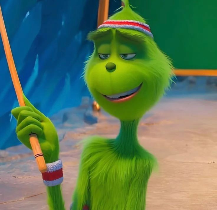 the grinch is holding an umbrella in his hand