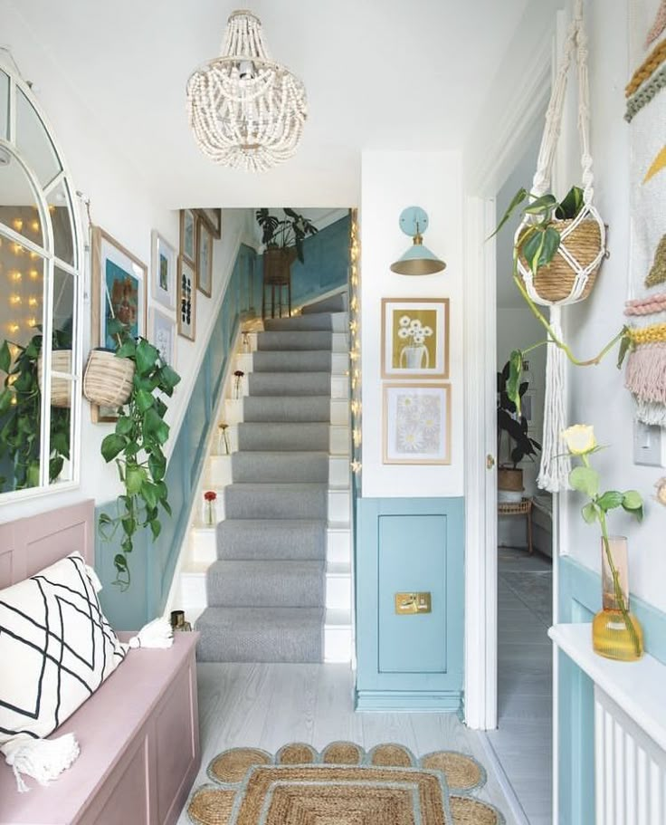 the hallway is decorated in pastel blue and white with lots of hanging decorations on the wall