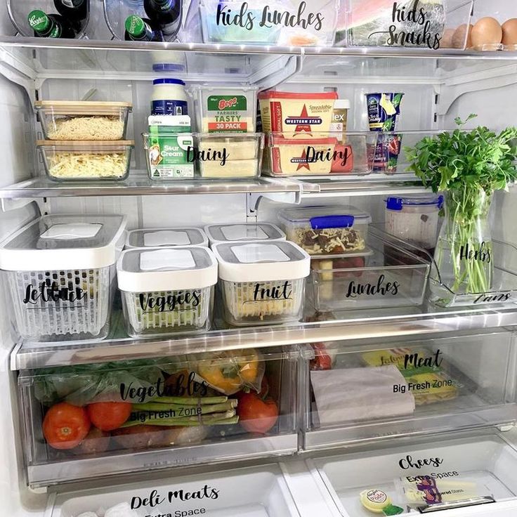 an open refrigerator filled with lots of food and containers full of vegetables, eggs, meats, and other items