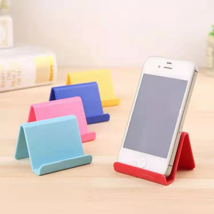 a cell phone sitting on top of a wooden table next to other colorful pieces of furniture