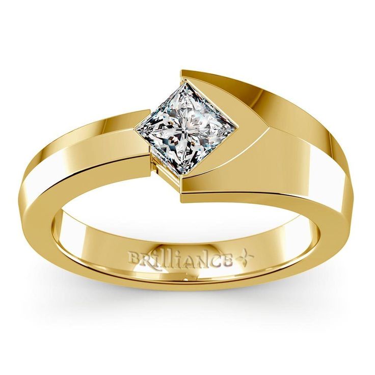 a yellow gold ring with a princess cut diamond