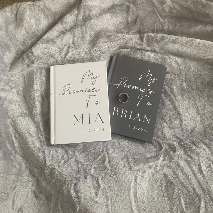 a book and ring laying on a bed