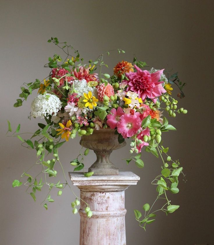 a vase filled with lots of colorful flowers