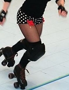 a woman riding a skateboard on top of a tiled floor