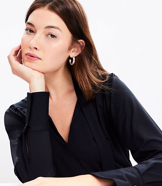 In a soft jersey knit, our modern bow blouse is softly shirred and cinched with a tie neck for an irresistibly feminine twist. V-neck with ties. Long sleeves with pleated button cuffs. Back yoke. Shirttail hem.,Bullet1:25 1/2" long,Imported:Imported,Fit:Fit: Classic — follows your contours with a little room,Length:Length: Regular - hits below natural waist,Fabrication:92% Lyocell 8% Spandex,Garment Care:Machine Washable Loft Jersey Bow Blouse Size XS Black Women's by Loft Size Regular - XS Blac Tie Neck Tops For Office In Fall, Fitted Tie Neck Top For Workwear, Fall Office Tops With Tie Neck, Casual Tie Sleeve Tops For Office, Casual Office Tops With Tie Sleeves, Chic Tie Neck Tops For Fall, Chic Tie Neck Tops For Workwear, Fitted Tops With Tie Sleeves For Work, Spring Workwear Tops With Tie Neck