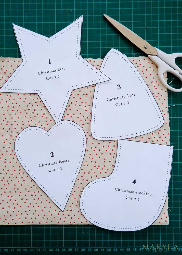 cut out pieces of paper to make a christmas heart ornament