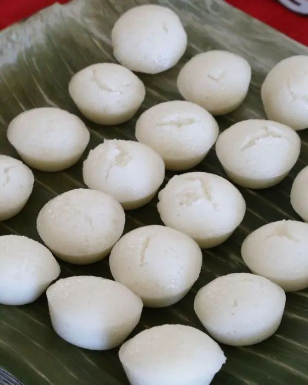 there are many small balls of food on a green platter with red cloth in the background