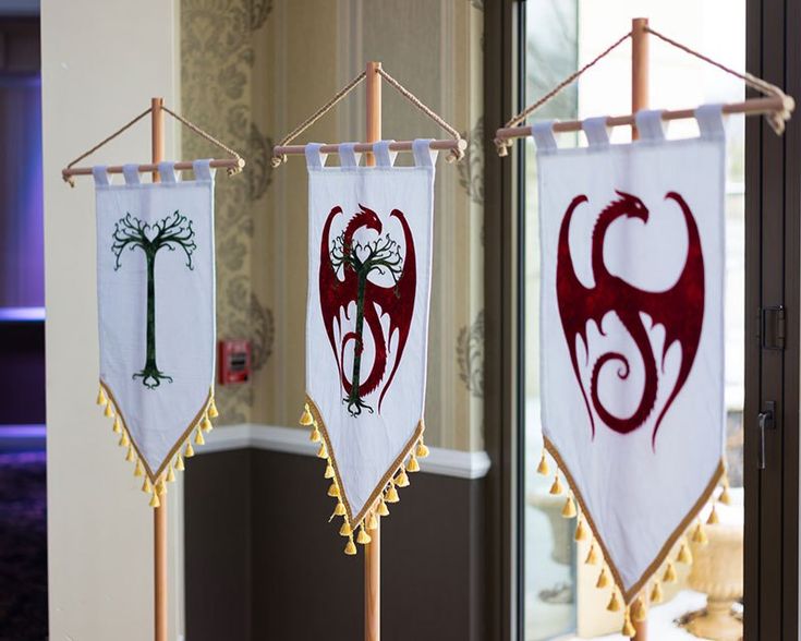 two flags with different designs hanging from clothes pins