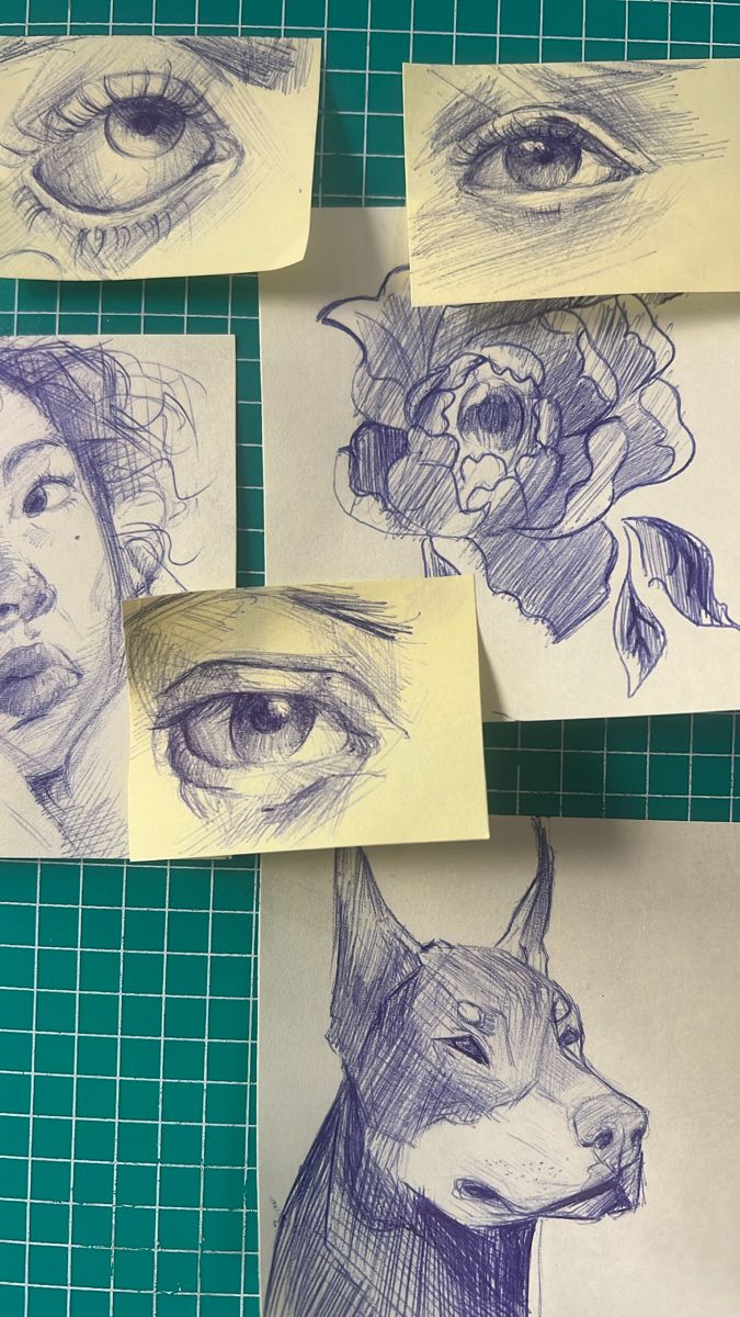 some drawings are on paper and have been placed next to each other with the eyes drawn