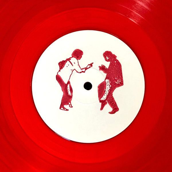 a red and white record with two people playing on the disc, one holding a cell phone