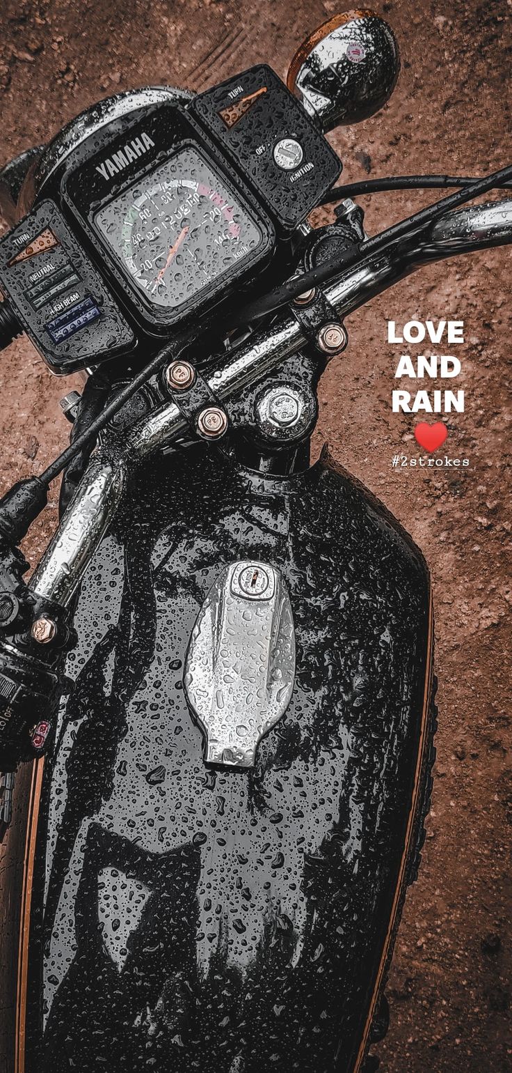 a close up of the handlebars on a motorcycle with rain drops all over it