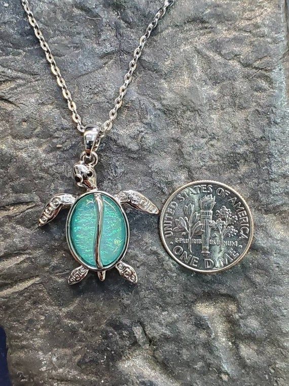 Beautiful turtle pendant in dichroic glass set in stainless steel. Comes with a chain Nickel-free Silver Turtle Jewelry, Silver Turtle Jewelry For Gifts, Silver Turtle Jewelry Gift, Silver Turtle Necklace For Gift, Iridescent Nickel-free Pendant Jewelry, Iridescent Metal Necklace Gift, Turquoise Stainless Steel Jewelry Gift, Turquoise Stainless Steel Jewelry As Gift, Turquoise Stainless Steel Jewelry As A Gift