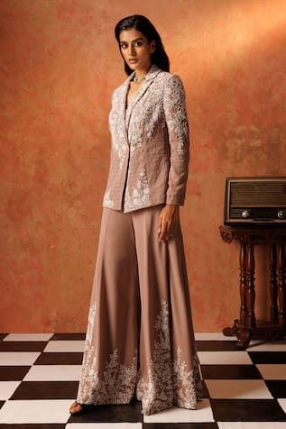 Sand drift padded blazer with floral, cutdana, pearl, sequin embroidery and geometric pattern texture. Paired with a flared pant, elevated with floral embroidery. Comes along with an inner padded bustier. - Aza Fashions Fitted Silk Nehru Jacket For Reception, Silk Fitted Nehru Jacket For Reception, Embroidered Fitted Palazzo Set For Evening, Traditional Tailored Sets With Resham Embroidery, Fitted Silk Bandhgala With Chikankari Embroidery, Fitted Palazzo Set With Set-in Sleeves, Fitted Front Open Palazzo Set, Fitted Silk Pant Set For Reception, Silk Fitted Pant Set For Reception