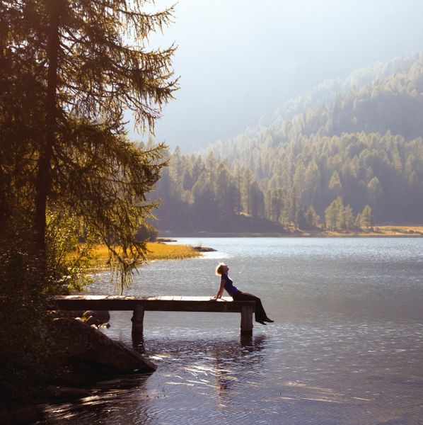 a person sitting on a bench in the middle of a body of water with a quote above it