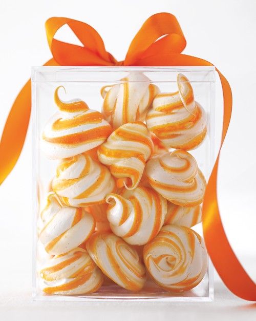 orange and white swirled cookies in a clear gift box with an orange ribbon on the side