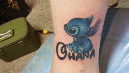 a small tattoo on the leg of a person with an elephant and word ohana