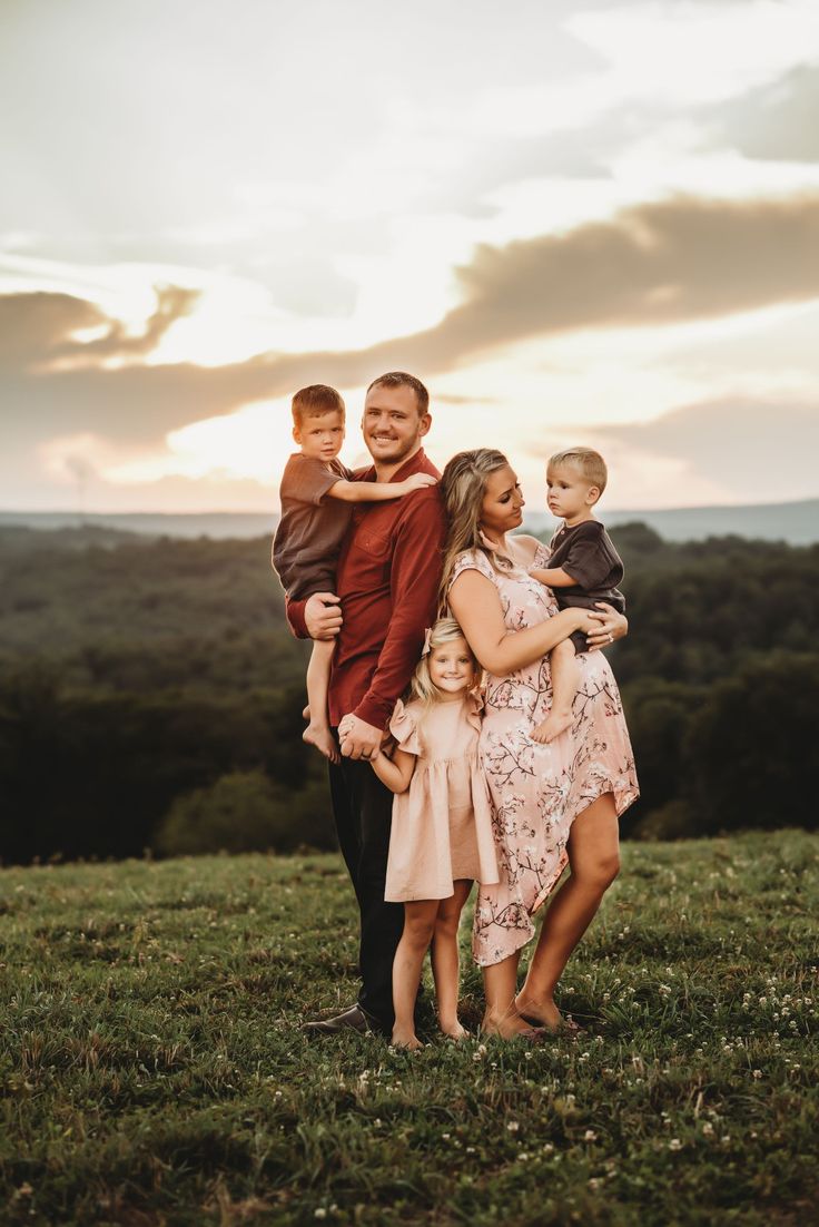 a family posing for a photo in the field