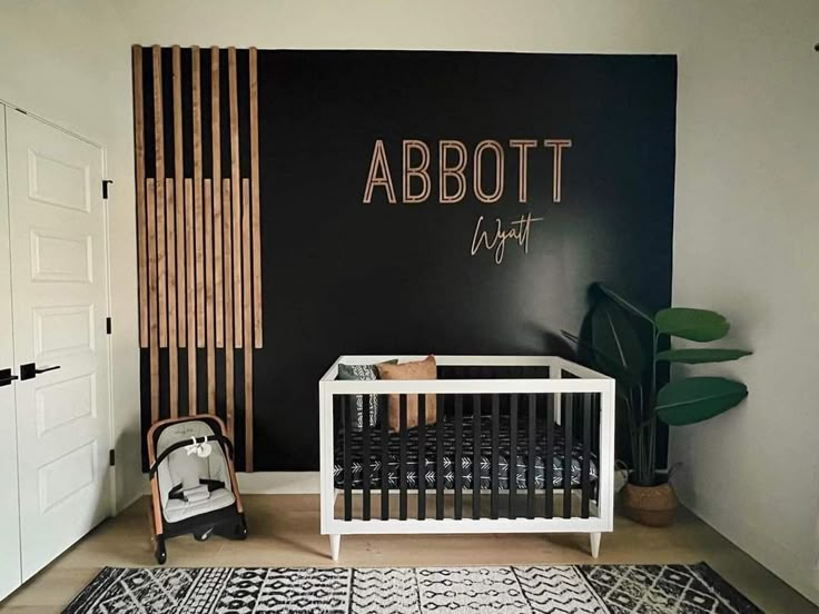 a baby's room with a black and white wall, wooden slatted walls, and a crib in the corner