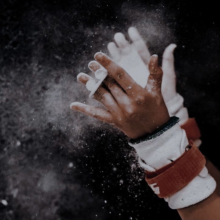 a person's hands are covered in powder while they hold their hand out to the camera