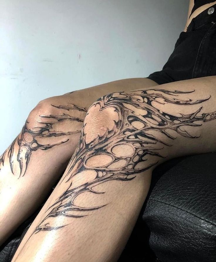 a woman's legs with tattoos on them