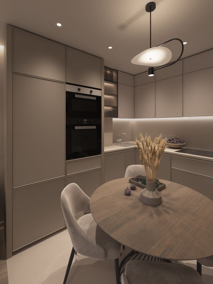 a kitchen with a table and chairs next to an oven in the wall behind it