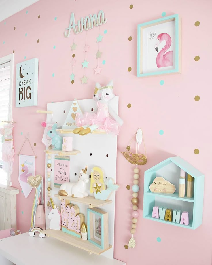 a child's bedroom with pink walls and gold polka dots