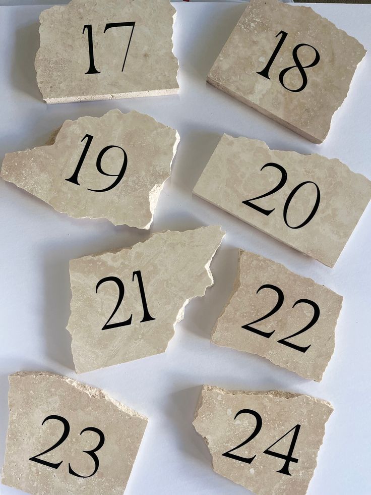 several pieces of paper with numbers on them sitting next to each other in front of a white background