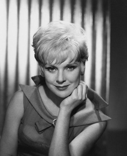 an old black and white photo of a woman with blonde hair posing for a portrait