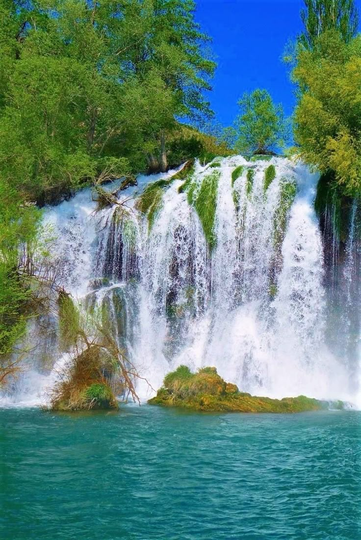 a large waterfall with water cascading over it