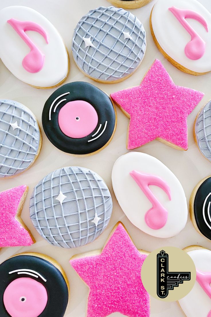 decorated cookies in the shape of musical instruments and music notes are arranged on a table