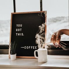 a person pours coffee into a cup in front of a sign that says you got this