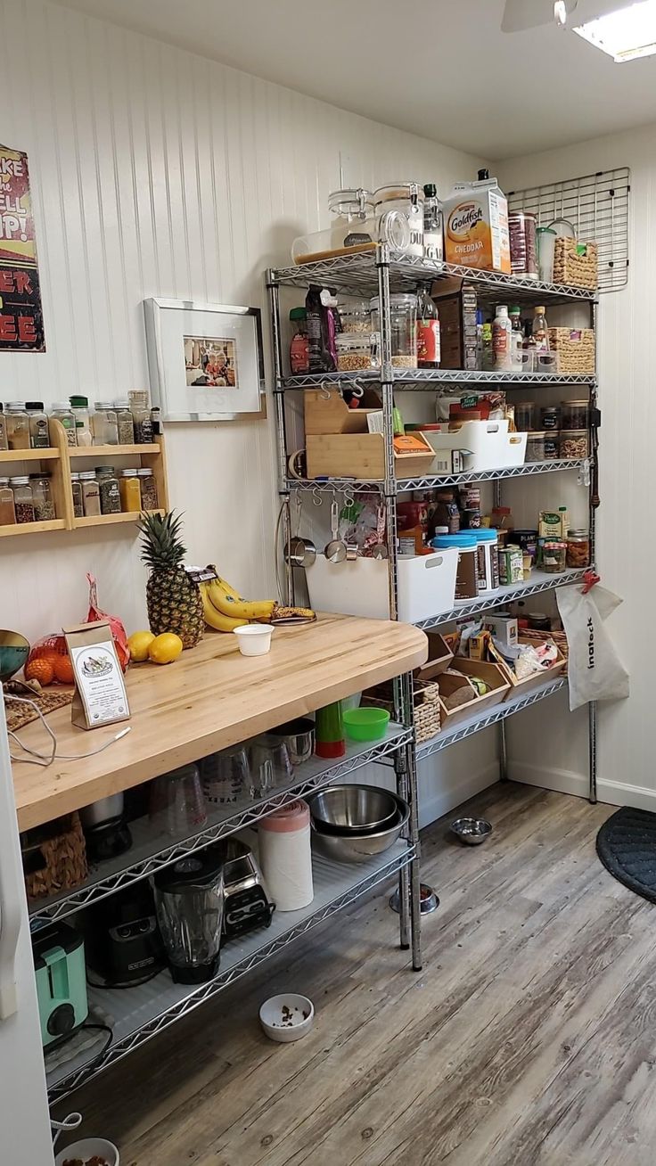 a kitchen filled with lots of clutter and cooking utensils on top of metal shelving