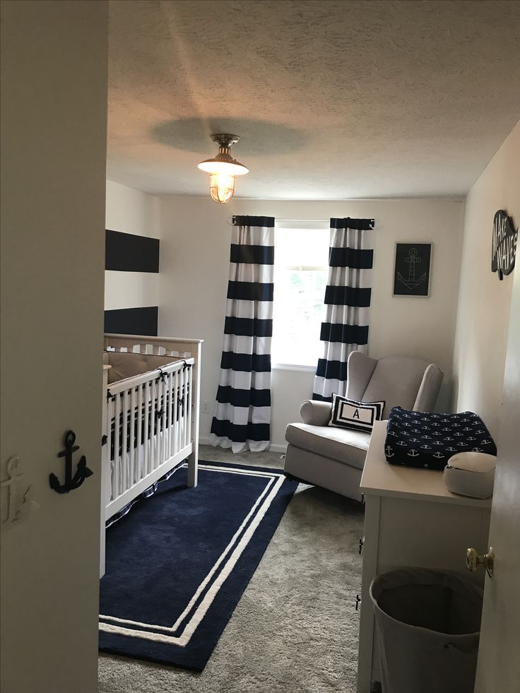 a baby's room with blue and white decor