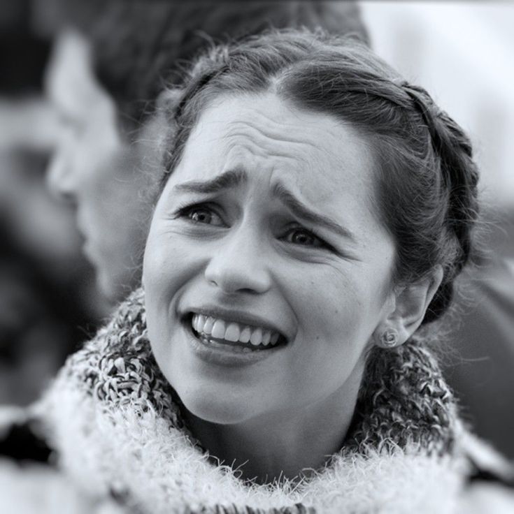 a black and white photo of a woman smiling