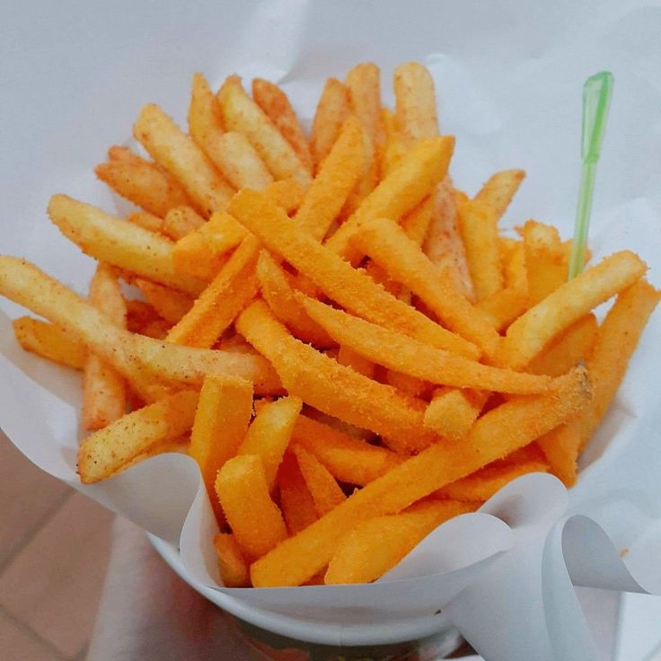 french fries are in a bowl on the table