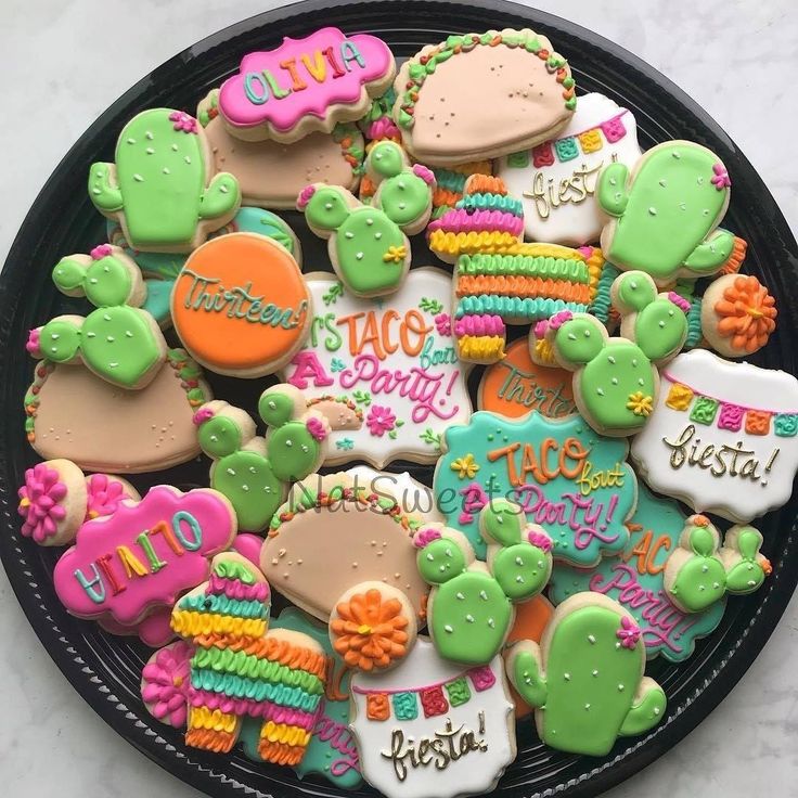 a plate full of decorated cookies that say hello kitty