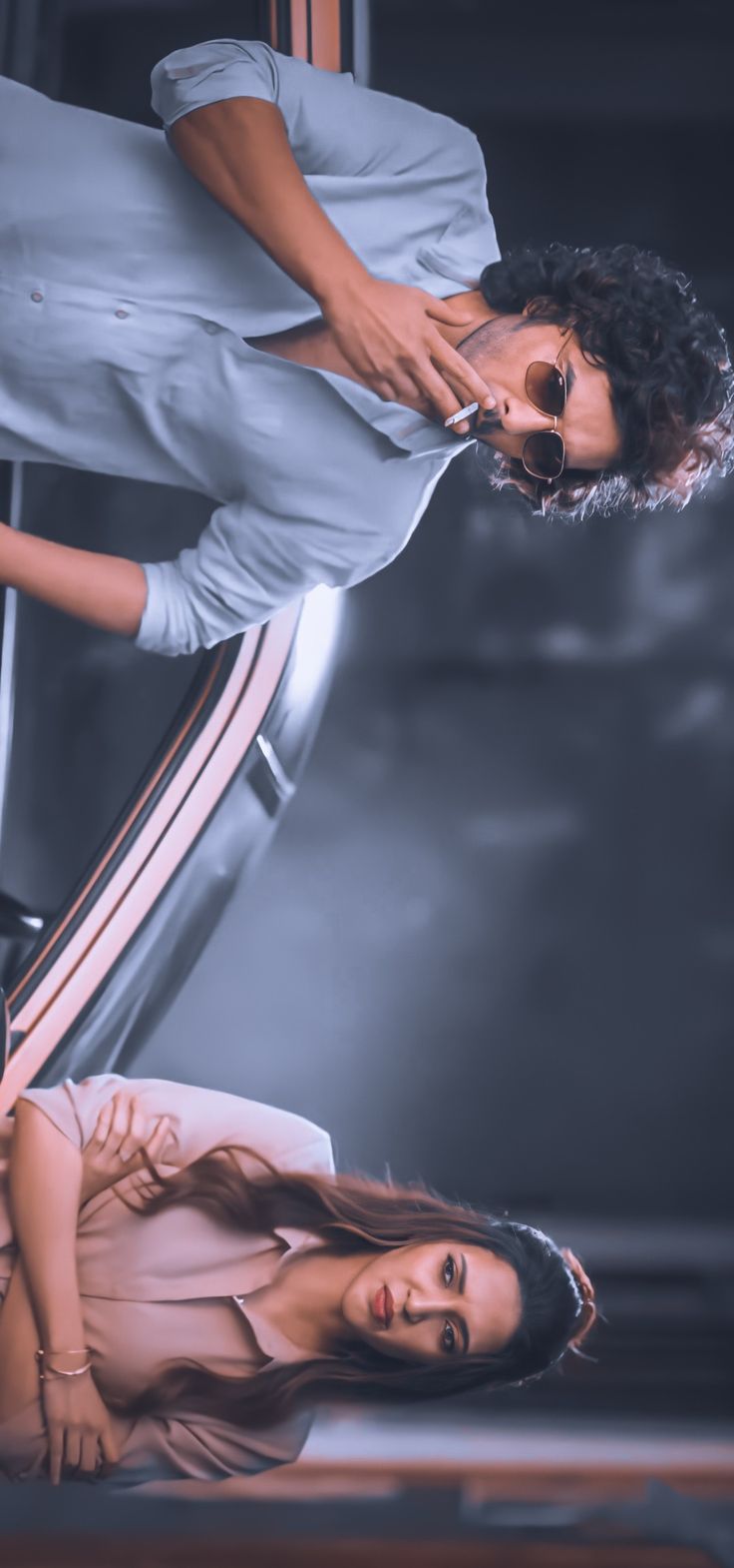 two women standing next to each other in front of a car