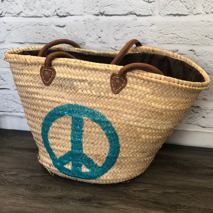 Peace Sign Turquoise Straw Beach Tote Handmade Turquoise Summer Bag, Handmade Turquoise Bags For Summer, Blue Basket Straw Bag For Travel, Blue Basket Bag For Vacation, Blue Straw Bag With Leather Handles For Vacation, Turquoise Beach Bag For Summer, Turquoise Beach Bag For Summer Vacation, Blue Bohemian Straw Bag For Shopping, Bohemian Blue Beach Bag For Shopping