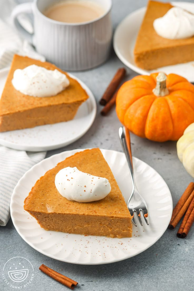 slices of pumpkin pie with whipped cream on top and cinnamon sticks next to it, along with two cups of coffee