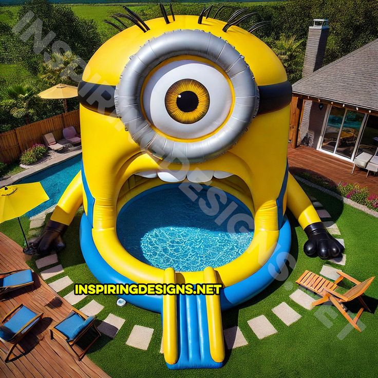 an inflatable swimming pool with a minion face on it and some chairs around it