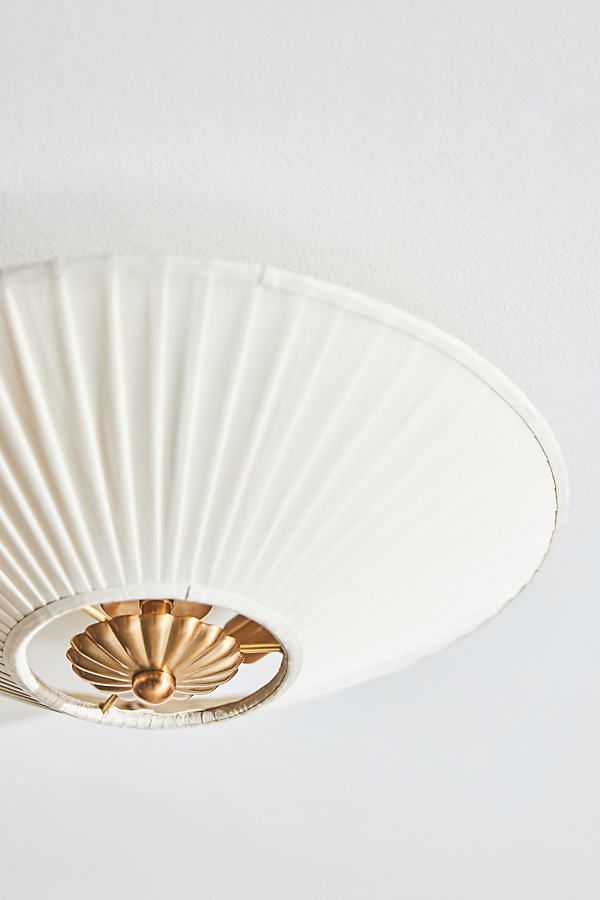 a close up of a white ceiling light with a fan on it's side