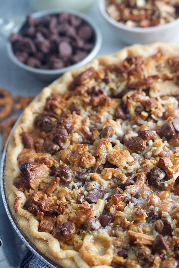 a pizza sitting on top of a pan covered in toppings next to chocolate chips