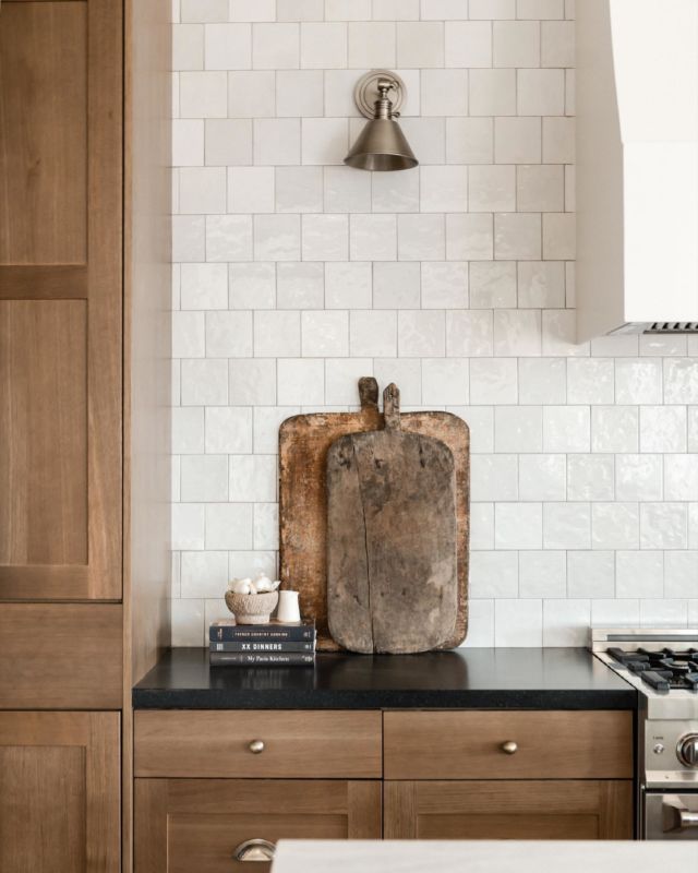 a wooden cutting board sitting on top of a kitchen counter