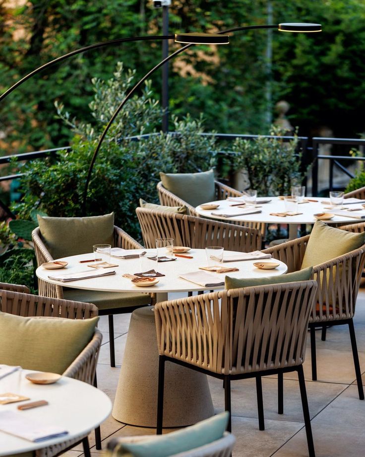 an outdoor dining area with tables and chairs