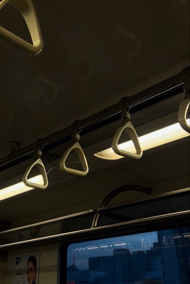 some lights are hanging from the ceiling on a train