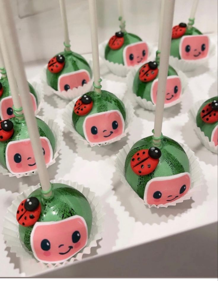 there are many cake pops with ladybugs on them