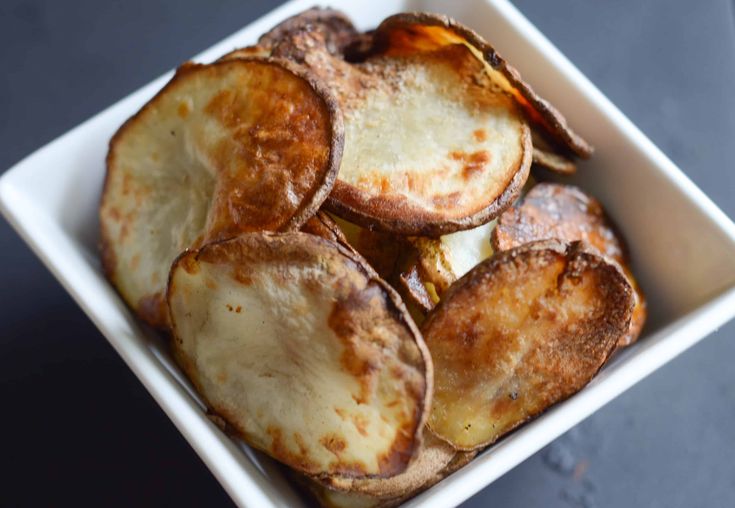 baked potato wedges in a white dish on a table