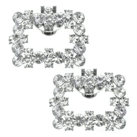 two pairs of earrings with clear stones in the shape of heart shaped shapes on white background