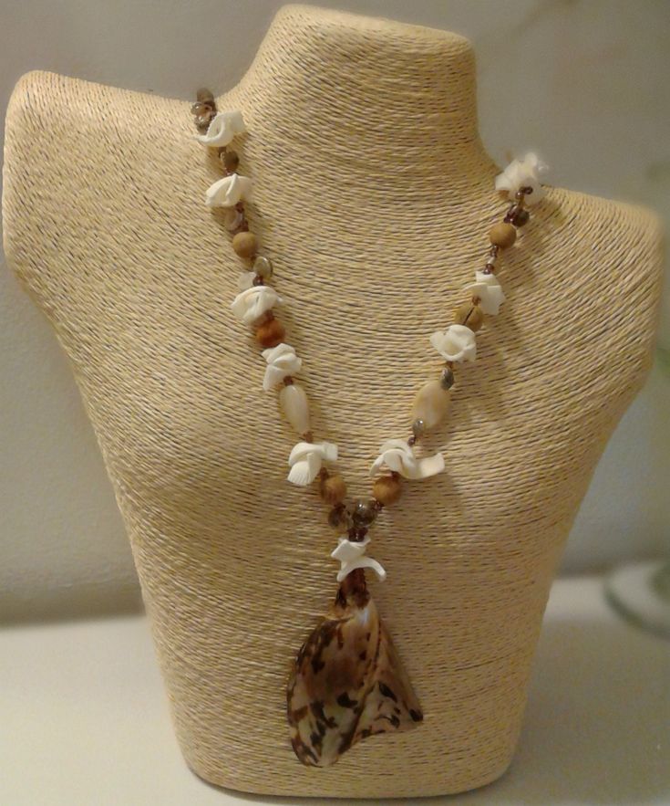 Beautiful shell beaded necklace with a variety of wood/shell/glass/resin! This is a statement piece! A beautiful accessory to add to your collection! Unique Beaded Necklaces With Wooden Beads For Beach, Bohemian Resin Jewelry For The Beach, Bohemian Resin Jewelry For Beach, Bohemian Beach Resin Jewelry, Bohemian Jewelry With Wooden Beads And Shell, Brown Shell Necklace As A Gift, Brown Beaded Shell-shaped Jewelry, Brown Beaded Shell Jewelry, Bohemian Beaded Necklaces With Natural Stones And Shell